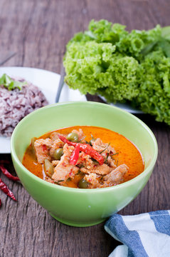 kitchen table with Pork panang curry and rice berry,  hot Sour c