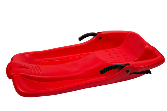Plastic red sled for skiing on white background
