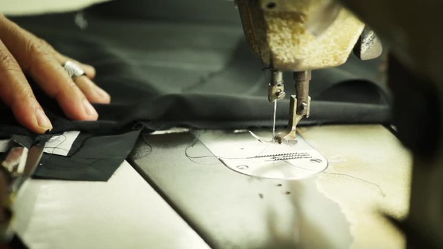 Sewing machine making stitches on a bespoke tailored suit