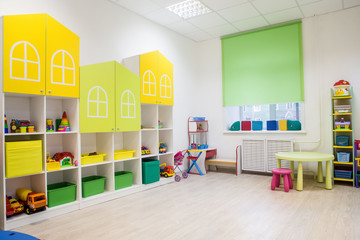 Interior of a modern kindergarten in yellow and green colors.