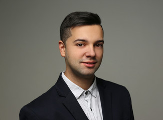 Handsome young man on grey background