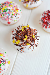 Cupcakes with white cream  and sprinkles on white background