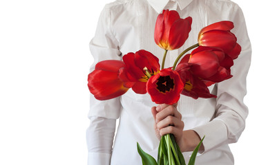 Isolated women in white classic shirt  keeps red tulips in her hand, person with  the bouquet of...
