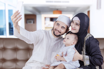 Arabian family taking selfie with smartphone
