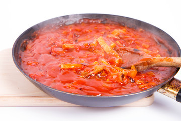 Tomato sauce with ham on a pan on a white background