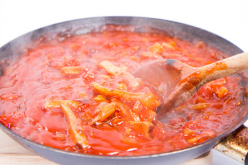 Tomato sauce with ham on a pan on a white background