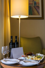 Beautifully arranged grapes and cheese with red wine on the table.