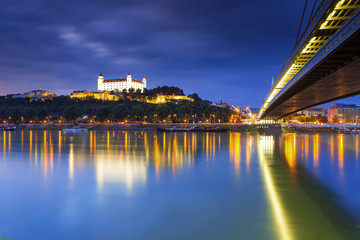 Obraz premium Bratislava castle,Parliament and the New bridge over Danube river with evening lights in capital city of Slovakia,Bratislava