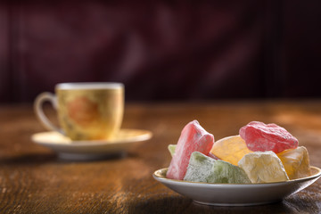 Turkish delight on plate and one cup of tea