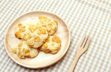 Cookies Cornflakes on wooden plate with fork