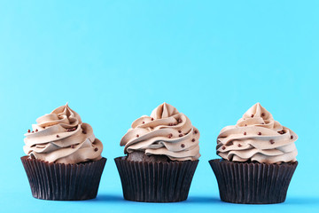 Tasty cupcakes on a mint background