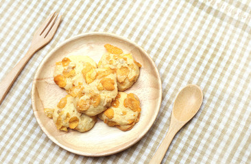 Cookies Cornflakes on wooden plate with spoon and fork 