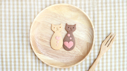 Butter and Chocolate Cookies Couple Cat with pink heart design on wooden plate and fork 