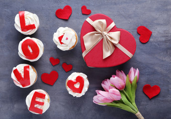 Tasty cupcakes on a grey wooden table