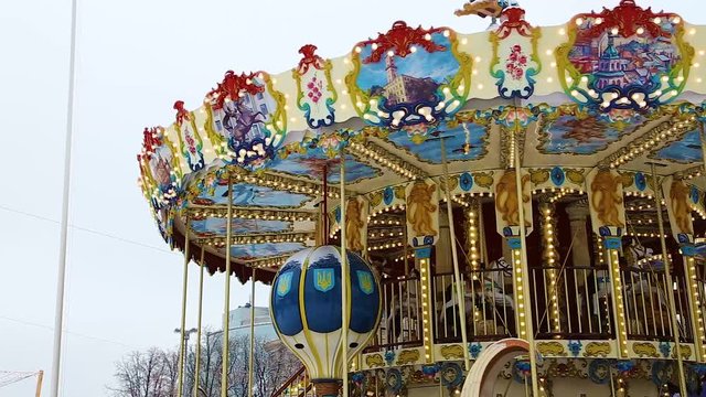 beautiful round children's carousel is spinning in an amusement park