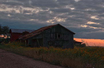 Fototapeta na wymiar Rustic old farm building at sunset