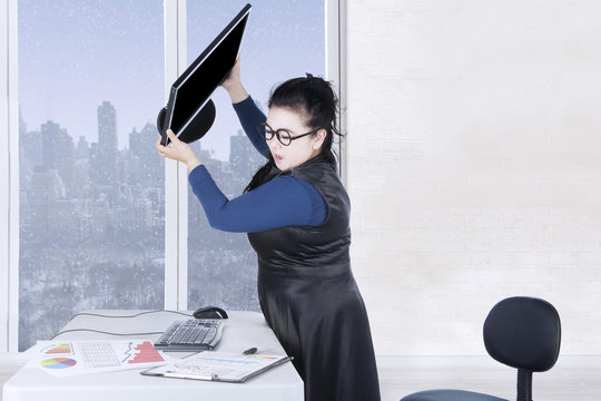 Female entrepreneur throws computer