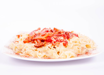 Tagliatelle mosse with tomato sauce with ham, sprinkled with parmesan