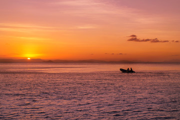 In a little boat towards the sunset