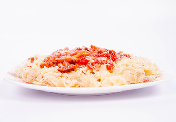 Tagliatelle mosse with tomato sauce with ham, sprinkled with parmesan