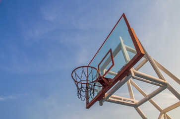 Obraz premium Photo of glass basketball hoop and blue sky background,basketbal