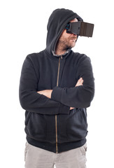 Man with hood and crossed arms use a virtual reality device