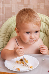 Funny baby for the first time on their own eating adult food