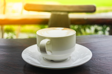 Close up white cup of Coffee, latte on the wooden table
