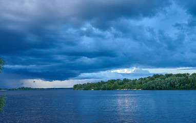 Landscape. The wide river, the sandy coast of the river overgrow