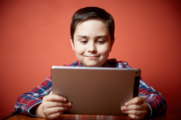 cute boy playing tablet computer