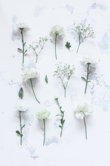 Flowers composition. Pattern made of white flowers on gray background. Flat lay, top view