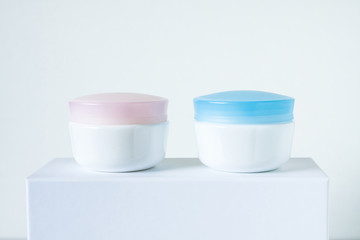 Cosmetic  jars mock up, for day and night face and skin care cream. Spa and beauty saloon motif wallpaper. 