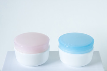Cosmetic jars mock up , for day and night face care cream. Beauty saloon motif wallpaper.
