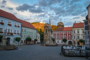 Fototapeta premium Renaissance square in sunset with the Calvary on the Holy hill, Mikulov, Czech Republic