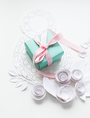 8 march, women`s day, a gift on a white napkin and white paper flowers