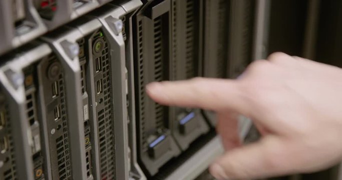 IT consultant power on a blade server in datacenter