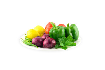 Fototapeta na wymiar plate with fresh vegetables on white Background