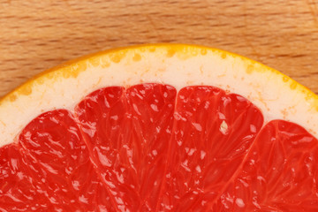 Closeup of grapefuit slice on wooden background