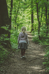 lost girl walking in spring forest