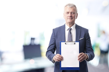 Man with clipboard. Shot of a senior sales man in his hand a clipboard with a blank paper while...