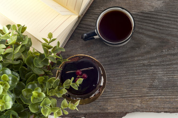 Old vintage books, cup of tea, cake and keys on rustic wooden table