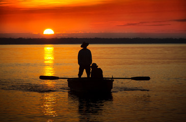 Fishermen on a boat in the background Caribbean Sunrise