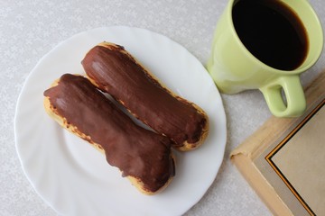 Chocolate eclairs and a cup of coffee