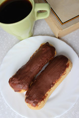 Chocolate eclairs and a cup of coffee