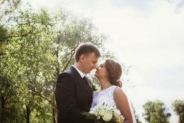 portrait of a couple bride and groom on  park background
