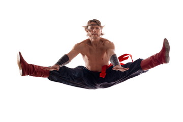 Actor Athlete man in trousers, shirtless dancing and jumping on white background