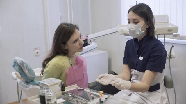Dentist makes procedures and treat teeth for a beautiful patient woman in dental clinic. Concept of healthy life