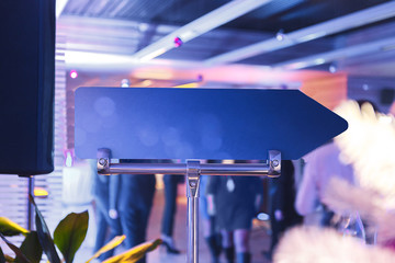 Blank blue pointer arrow pointing to the right, against the background of celebration