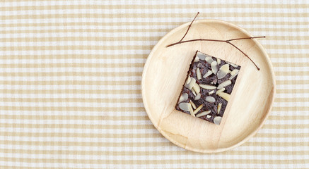 Chocolate Brownie on wooden plate on top top shot 