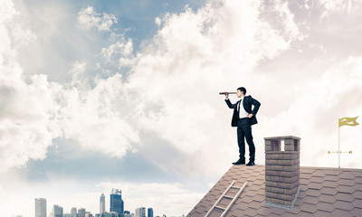 Mister boss on brick roof in search of something new. Mixed medi